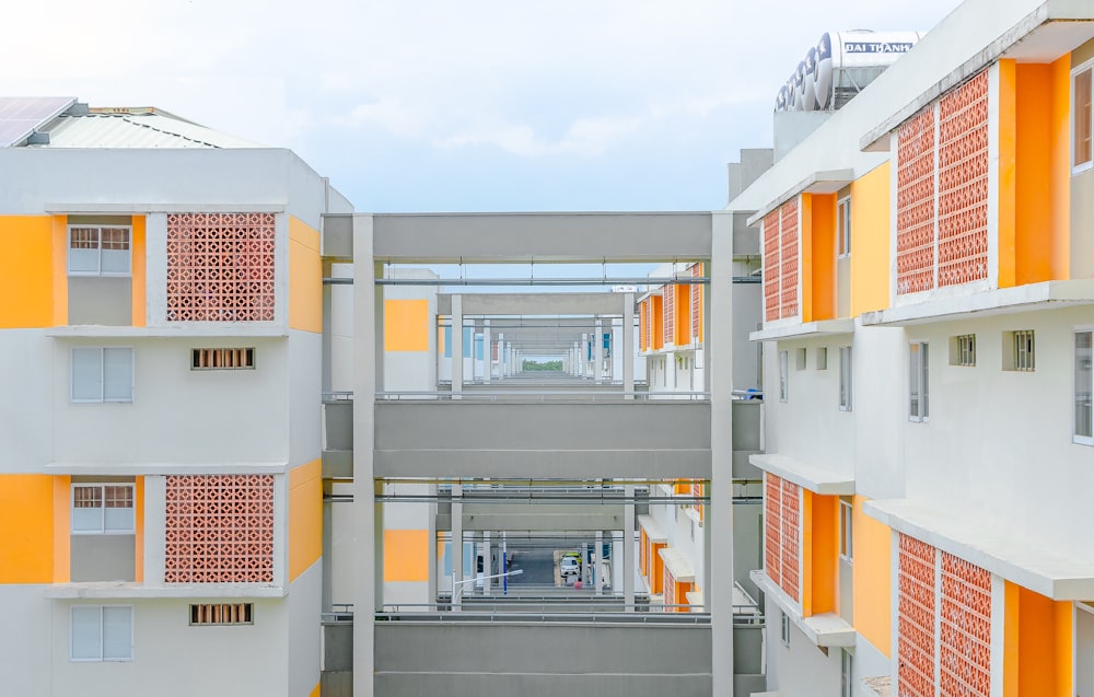 an apartment building with orange and white windows