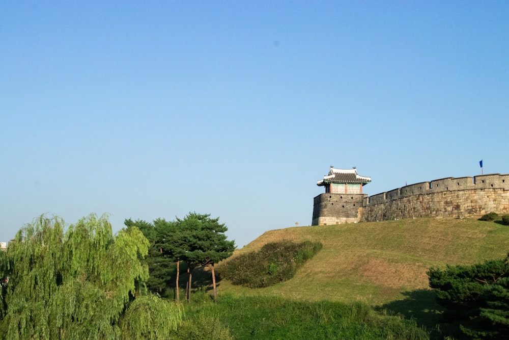 a tower on top of a grassy hill