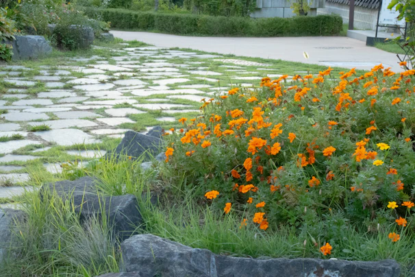 A freshly installed stone patio surrounded by vibrant flower beds in Vermilion, Ohio.