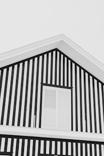 Close-up of a freshly painted elegant black and gold exterior wall with sharp, clean lines.