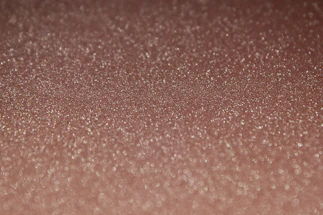 Close-up of shimmering nano powder particles under a microscope.