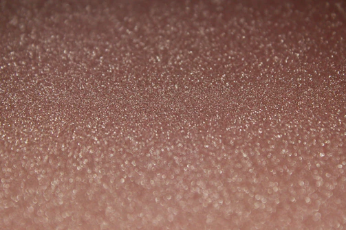 Close-up of shimmering nano powder particles under a microscope.