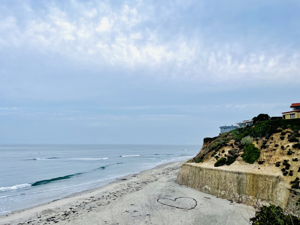 a sandy beach with a house on top of it