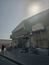 Cozy storefront of Samy's Brothers Mini Market with colorful produce displayed outside on a sunny day.