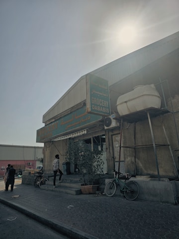 Front view of Ismael Mini Mart with bright signage and customers entering.