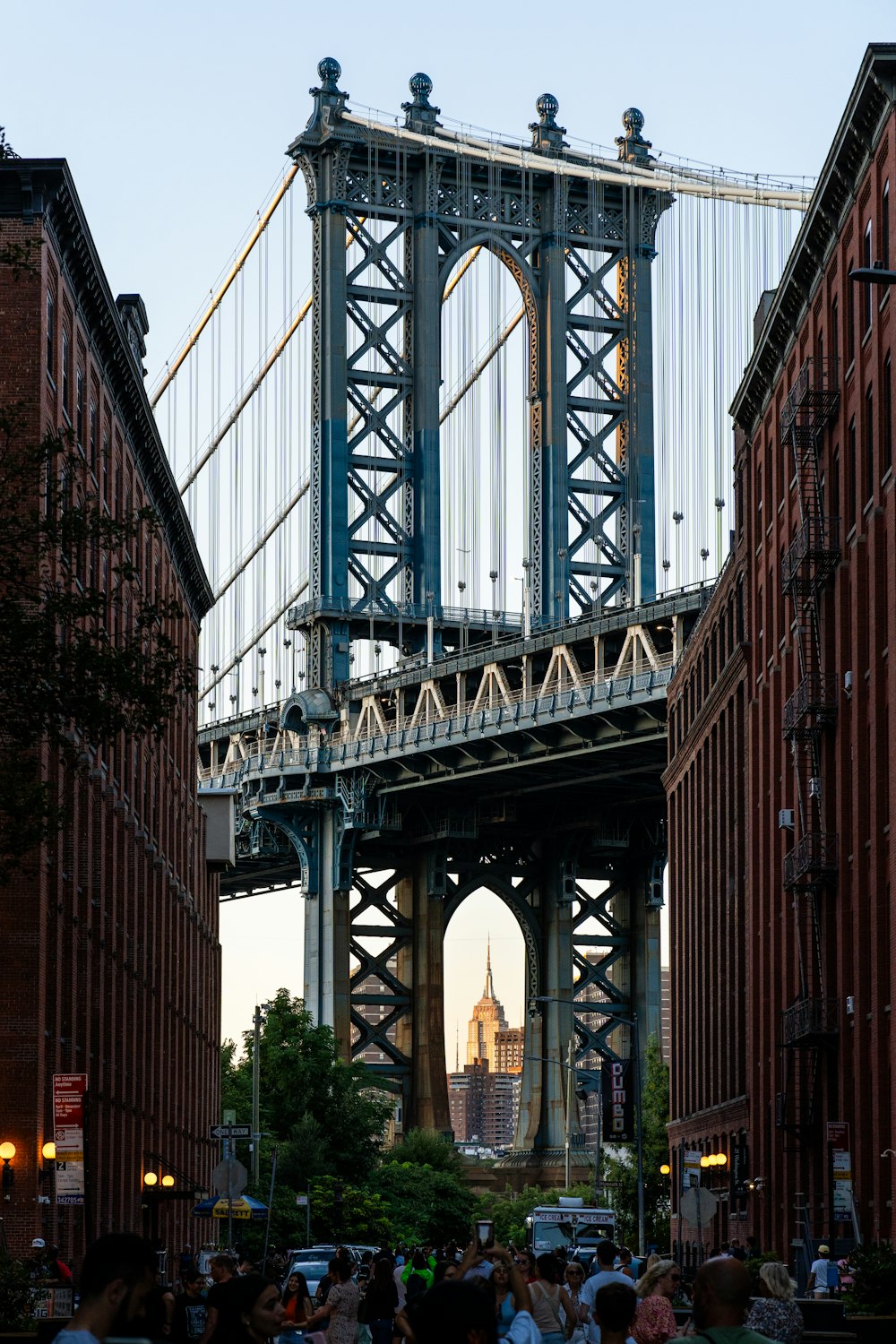 a group of people walking across a bridge