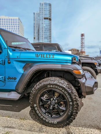 The sleek black Jeep Wrangler parked on a city street, serving fresh coffee from its side window.