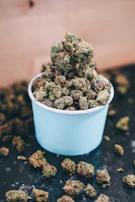 Berry-colored Blue Bubblegum buds resting on a rustic wooden surface.