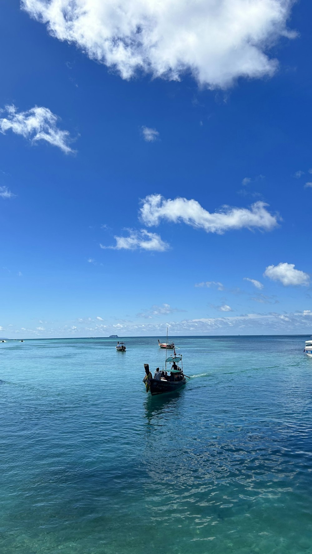 a couple of boats floating on top of a body of water