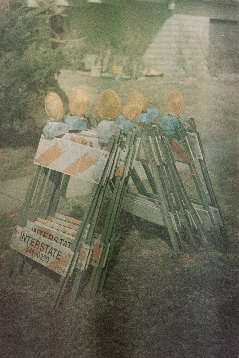 a pile of signs sitting on top of a grass covered field