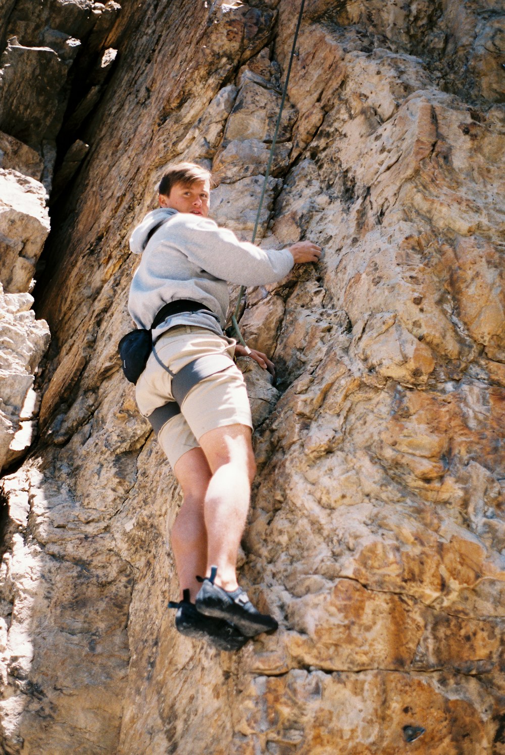 a man climbing up the side of a mountain