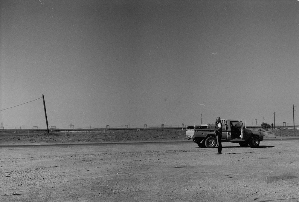 a black and white photo of a truck on a road