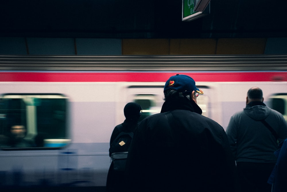 a group of people standing in front of a train