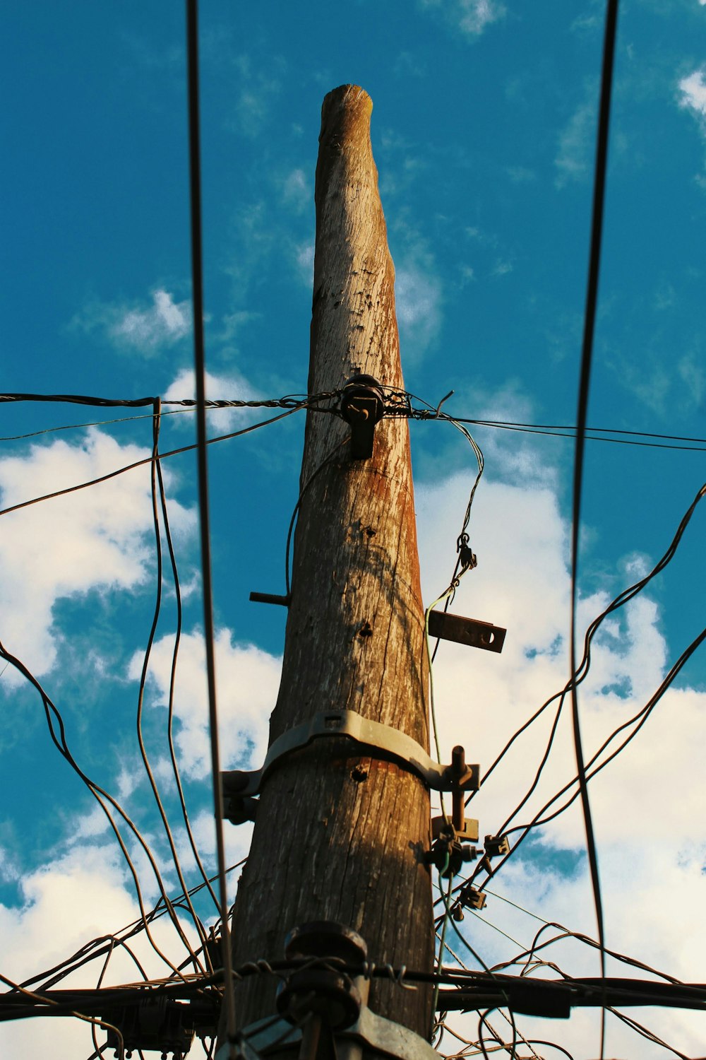 a telephone pole with wires and a sky background