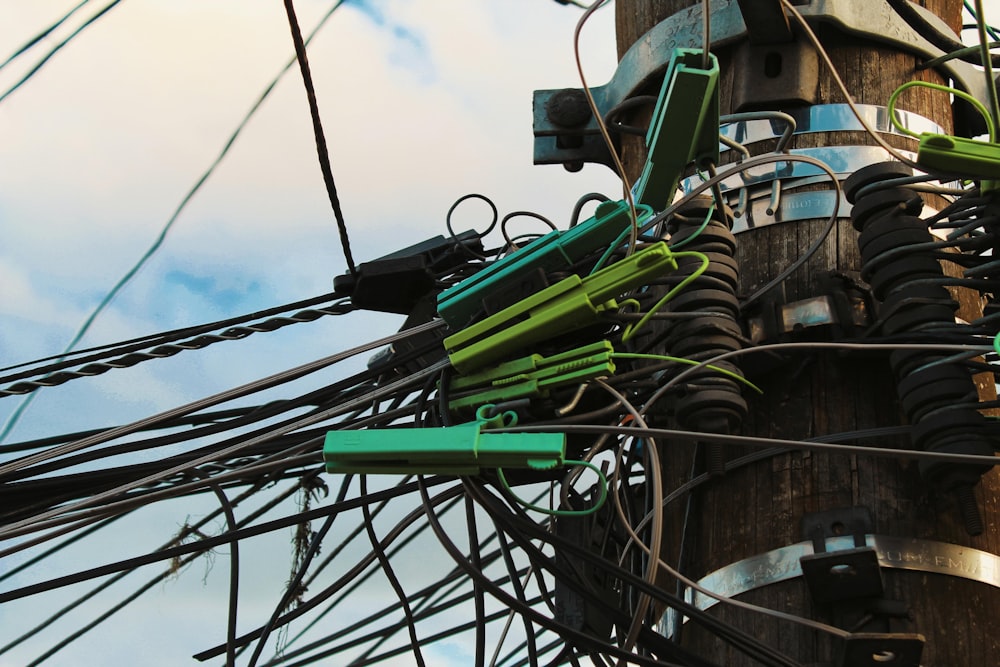 a telephone pole with many wires attached to it