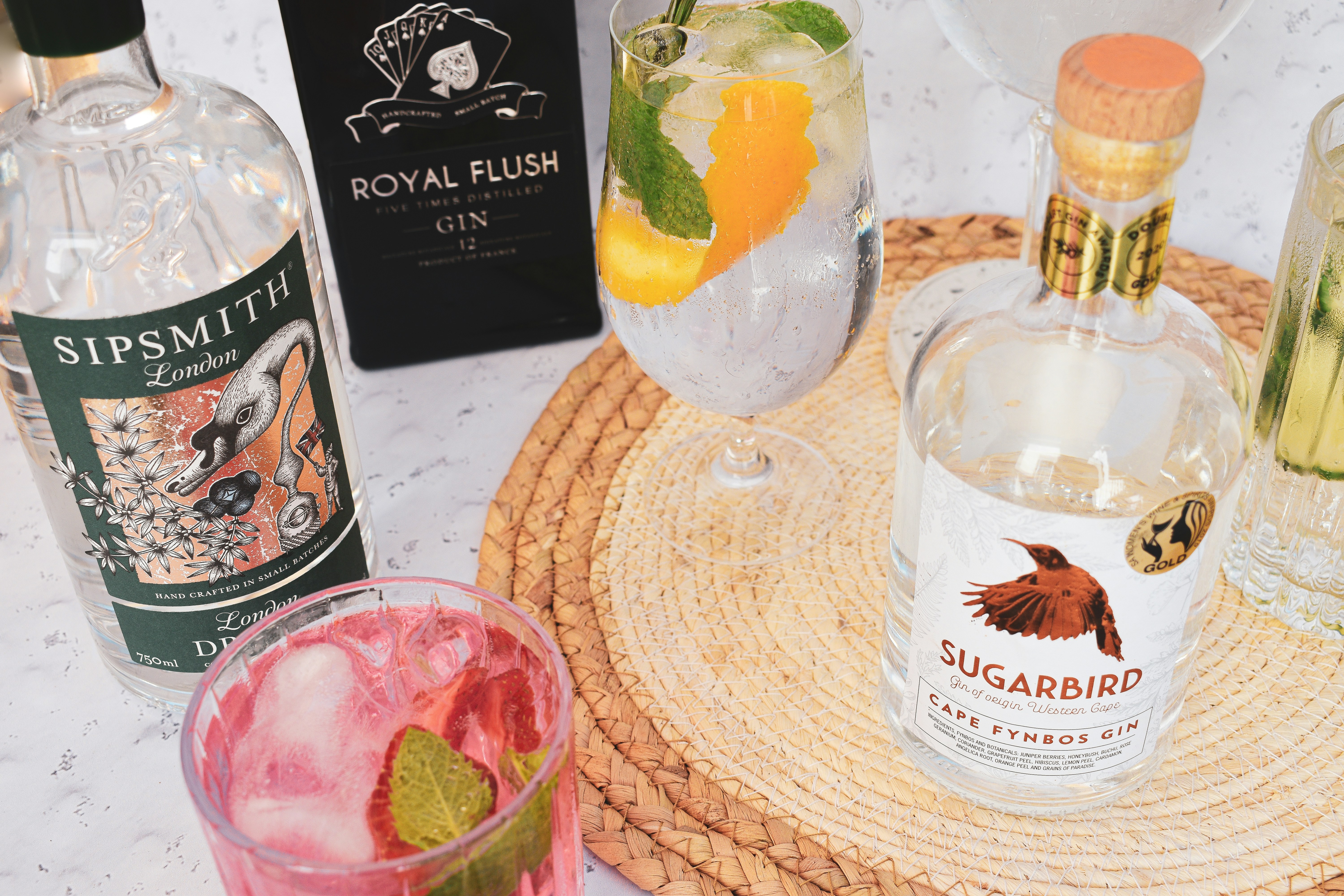 a tray with a bottle of gin, a glass of water, a bottle of