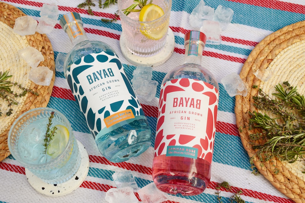 a table topped with bottles of alcohol and plates of food