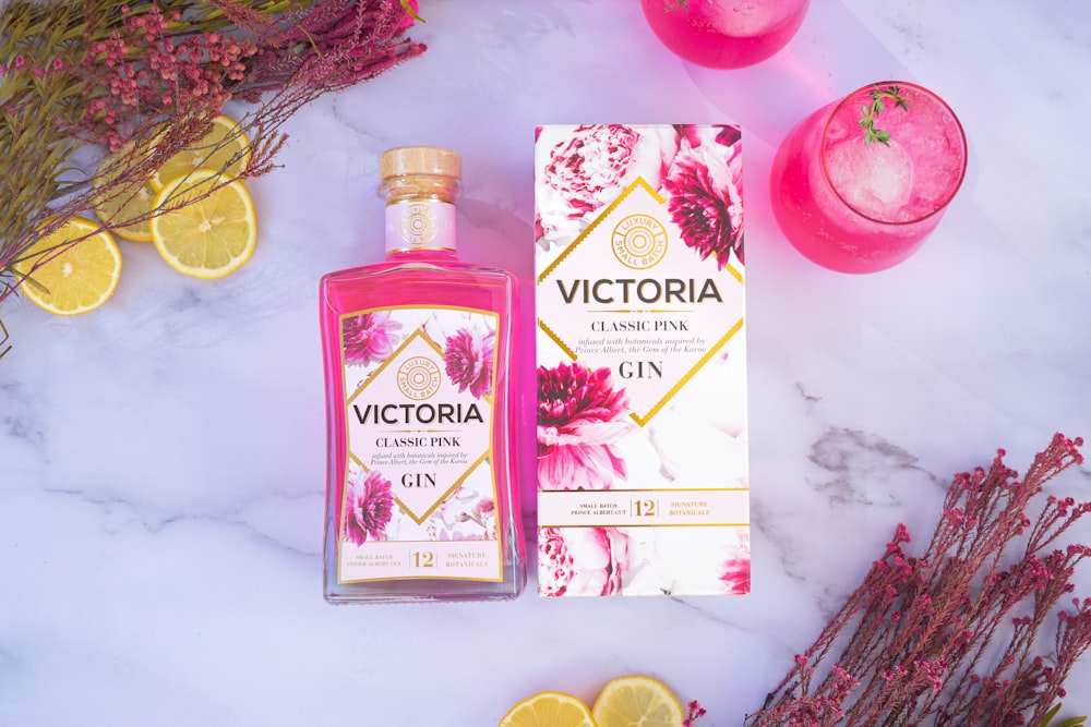 a bottle of victoria gin next to a box of gin