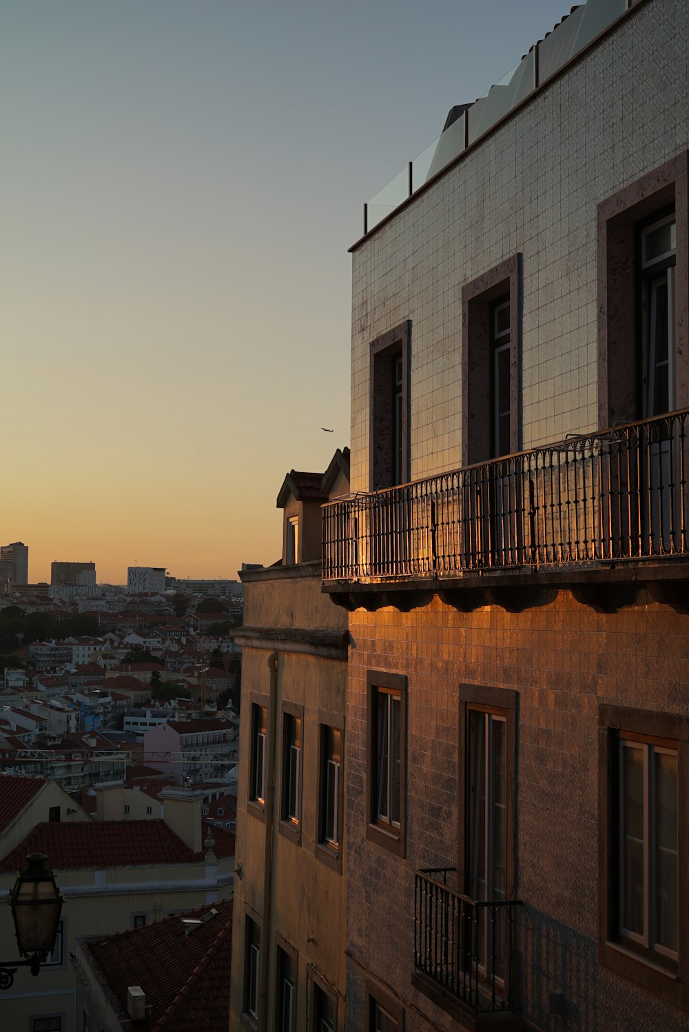 the sun is setting over a city with tall buildings