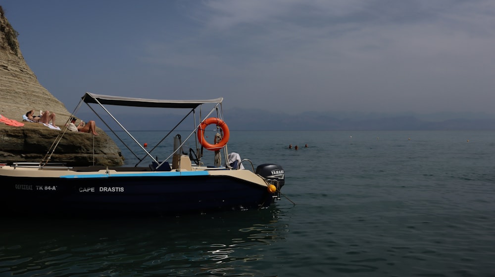 a small boat floating on top of a body of water