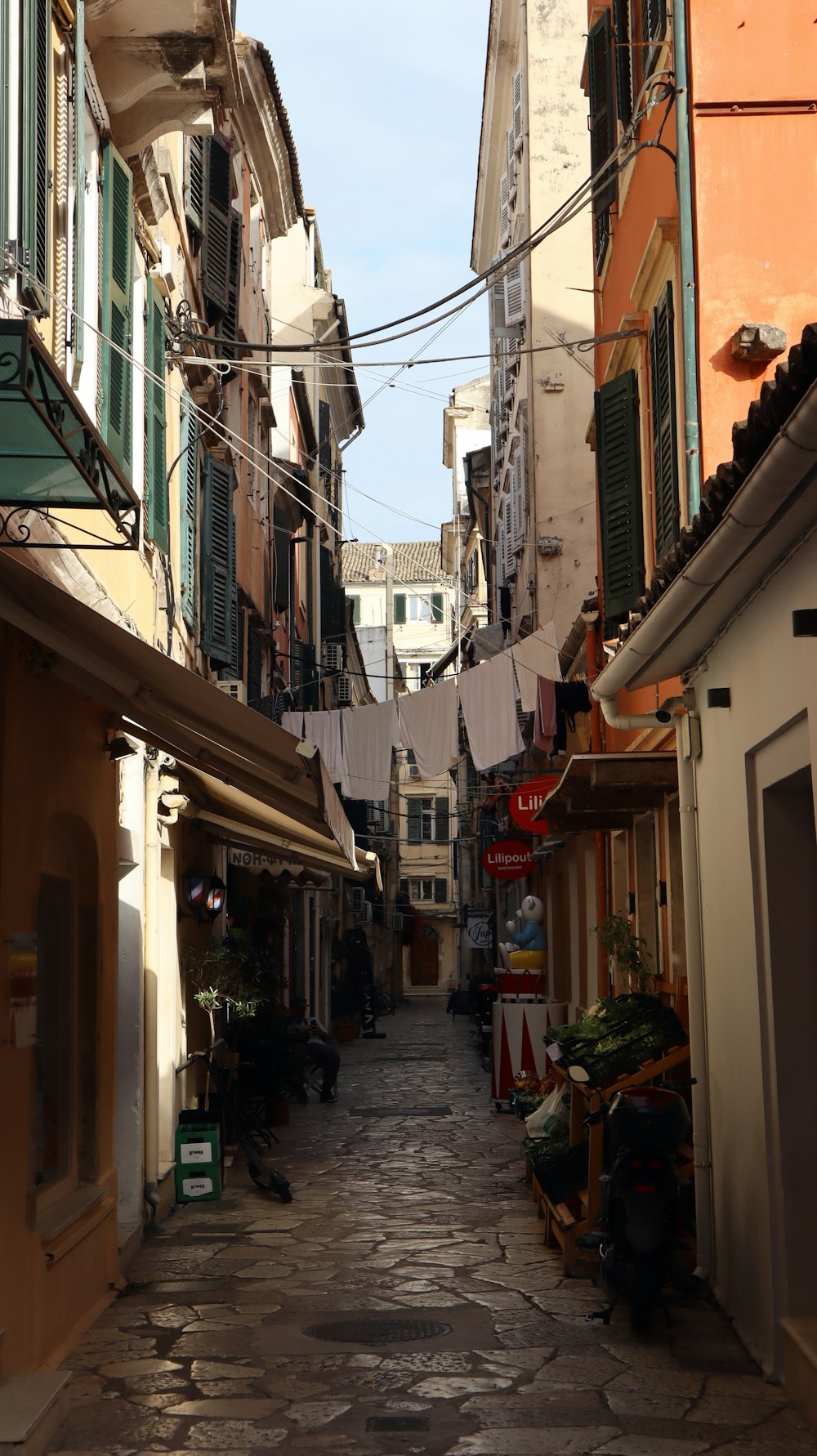 a cobblestone street lined with buildings and shops