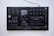 A black electronic music synthesizer with numerous knobs, buttons, and a small display screen in the center. It features labeled controls for various functions like volume, tempo, and different sound effects. The device appears to be designed for complex audio manipulation and production.