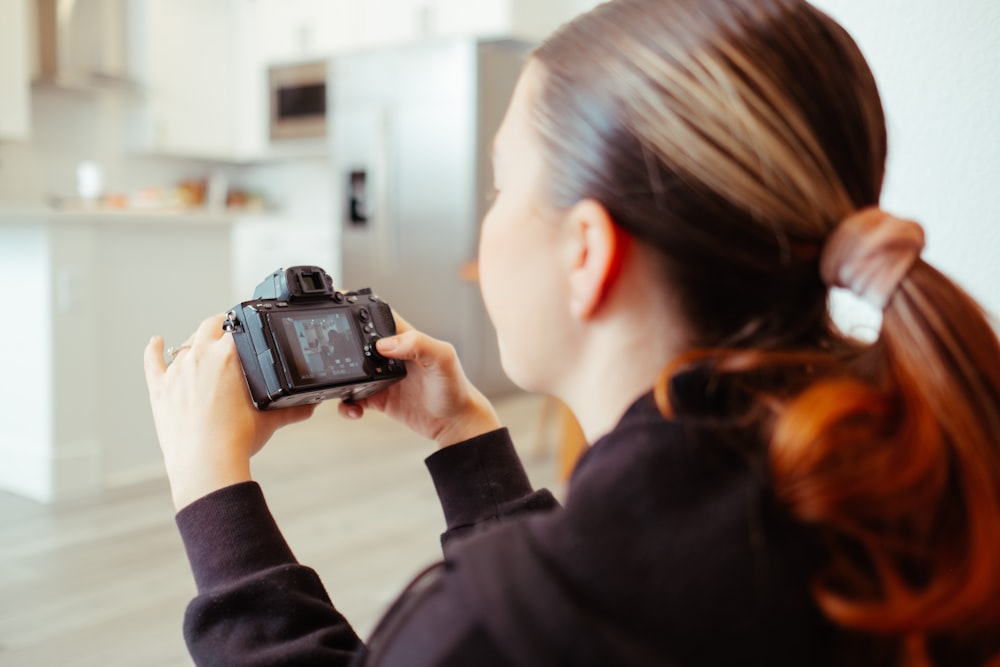 a woman taking a picture of herself with a camera