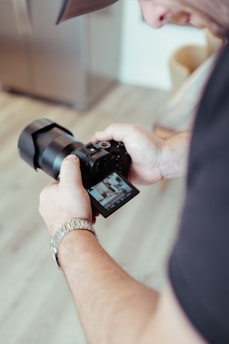 a man holding a camera in his hand