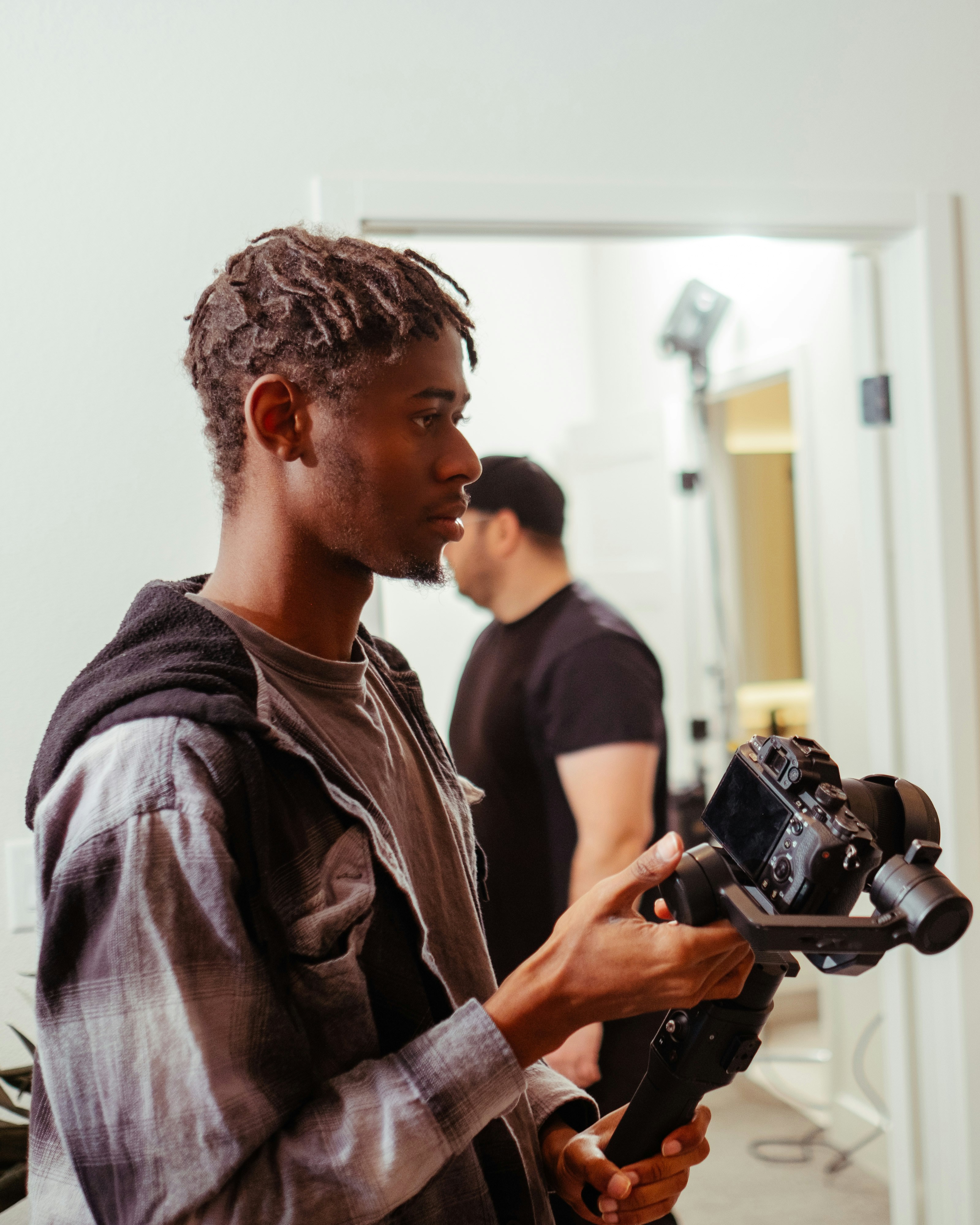 a man holding a camera in front of a mirror