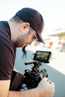 a man holding a camera and a cell phone
