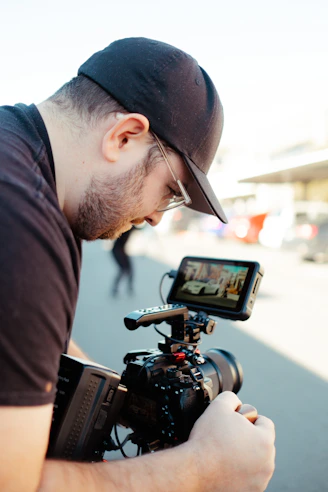 a man holding a camera and a cell phone