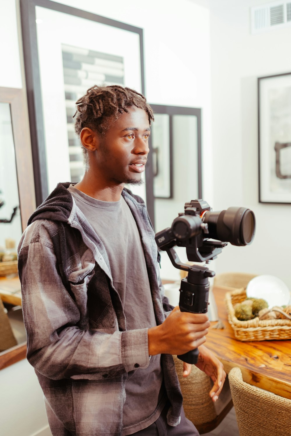 a man holding a camera and a tripod