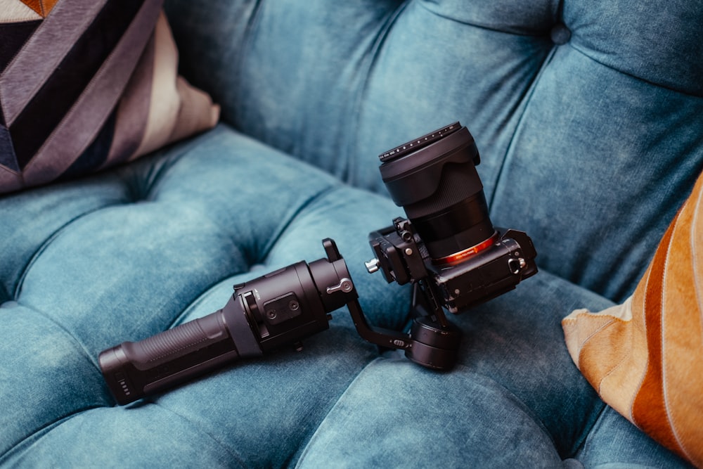 a camera sitting on top of a blue couch