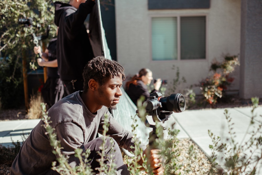 a man kneeling down in front of a camera