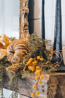 Seasonal 3D printed decorations featuring autumn leaves and pumpkins on a mantel.