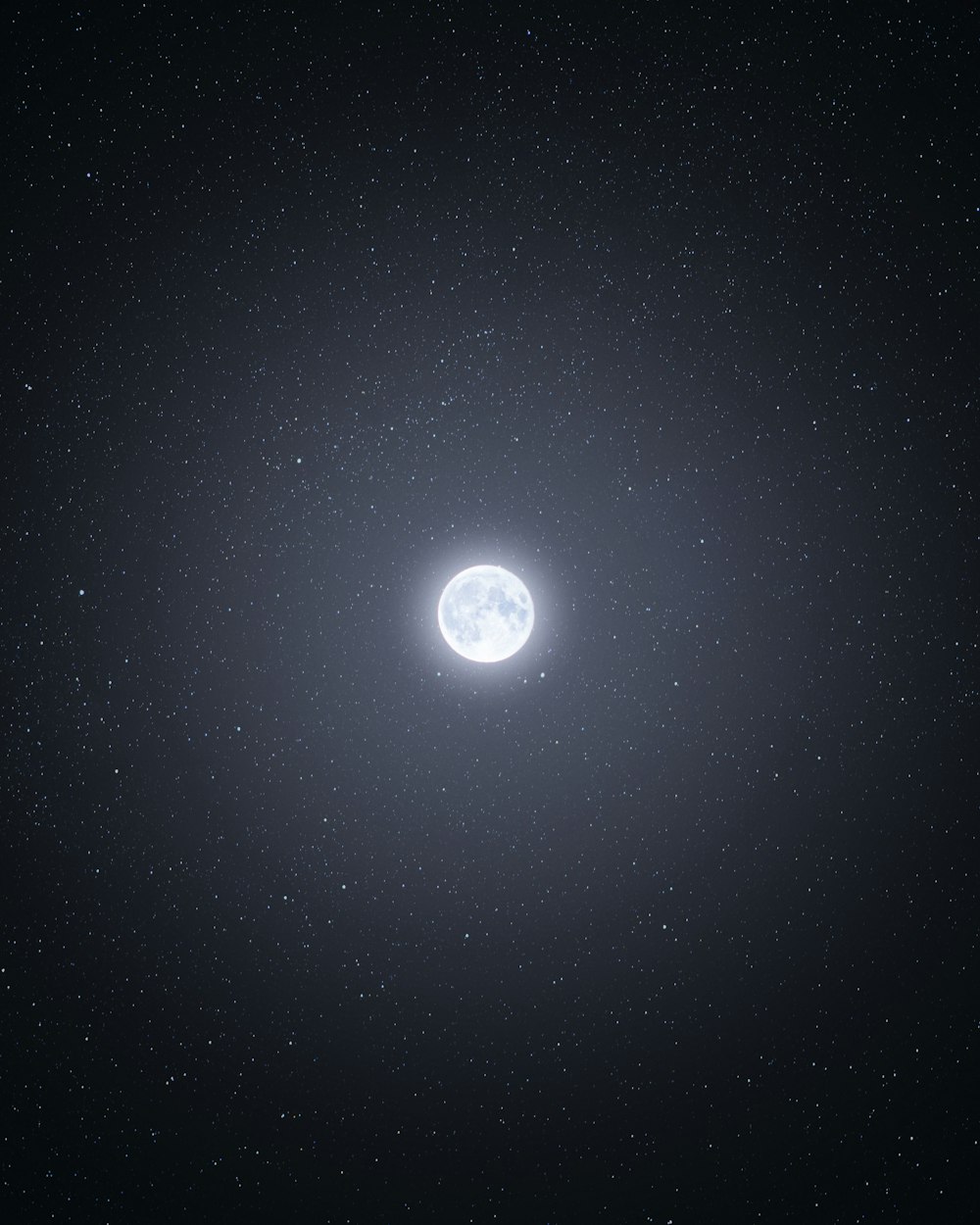 an image of a bright moon in the night sky