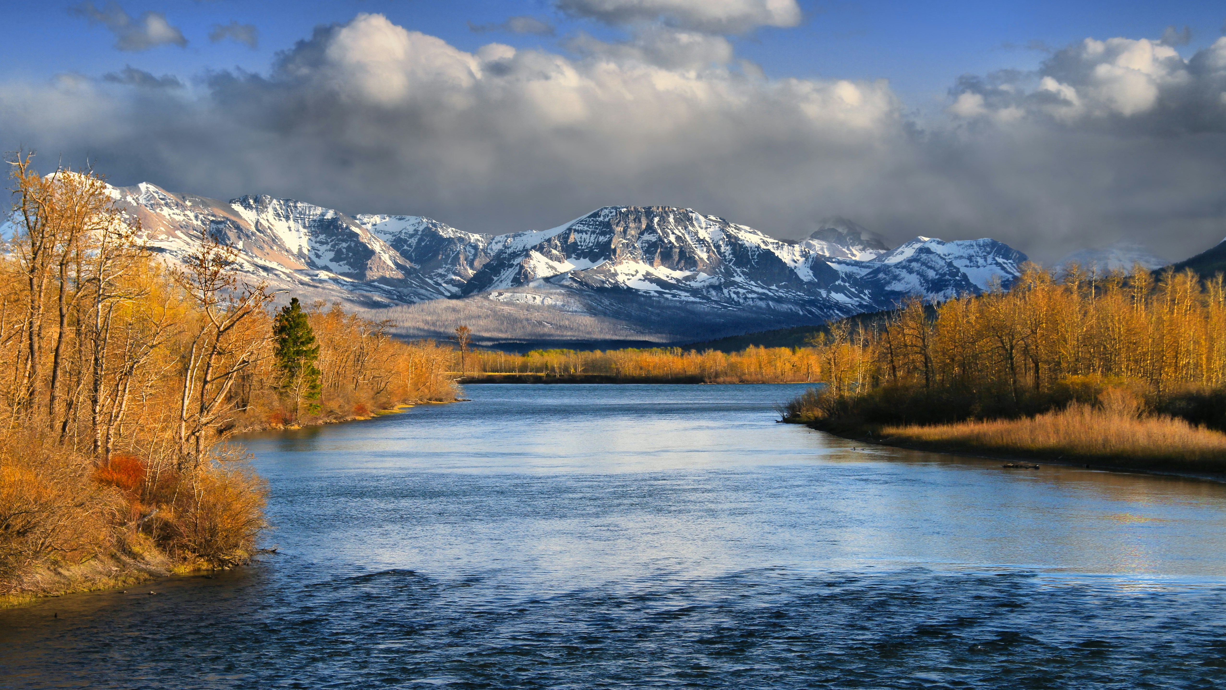 a river with mountains in the background
