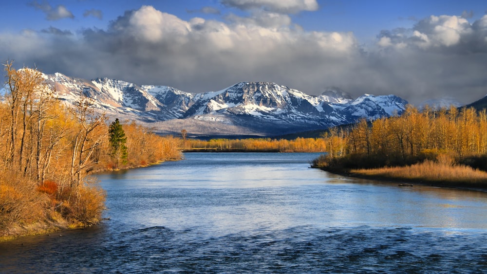 a river with mountains in the background