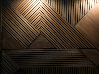 A handcrafted wooden room divider featuring geometric patterns and smooth finishes.