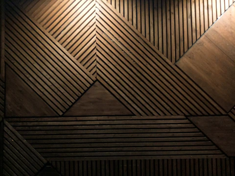A handcrafted wooden room divider featuring geometric patterns and smooth finishes.