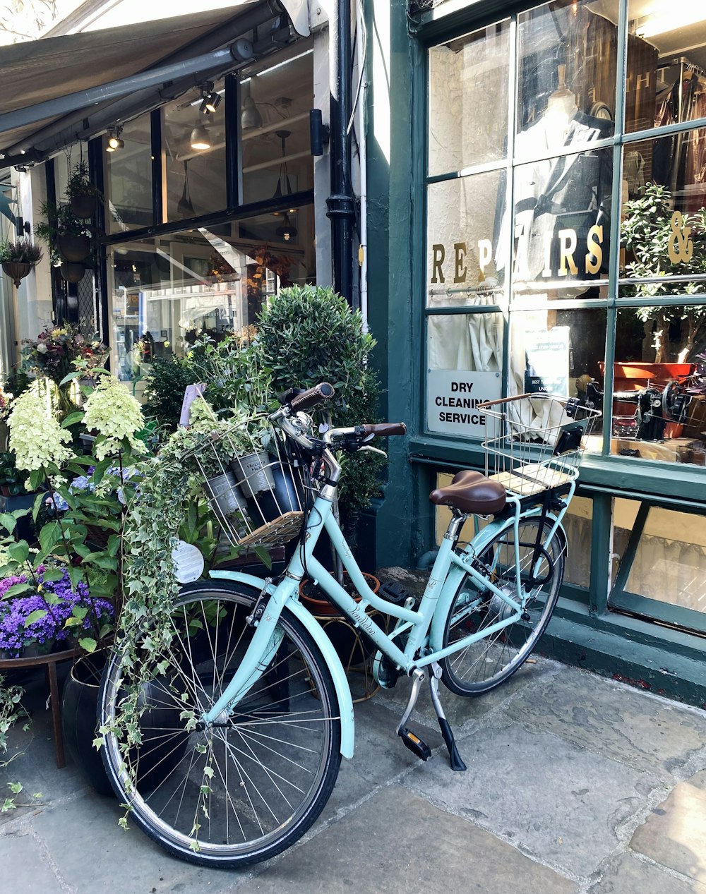 a bicycle parked outside of a flower shop