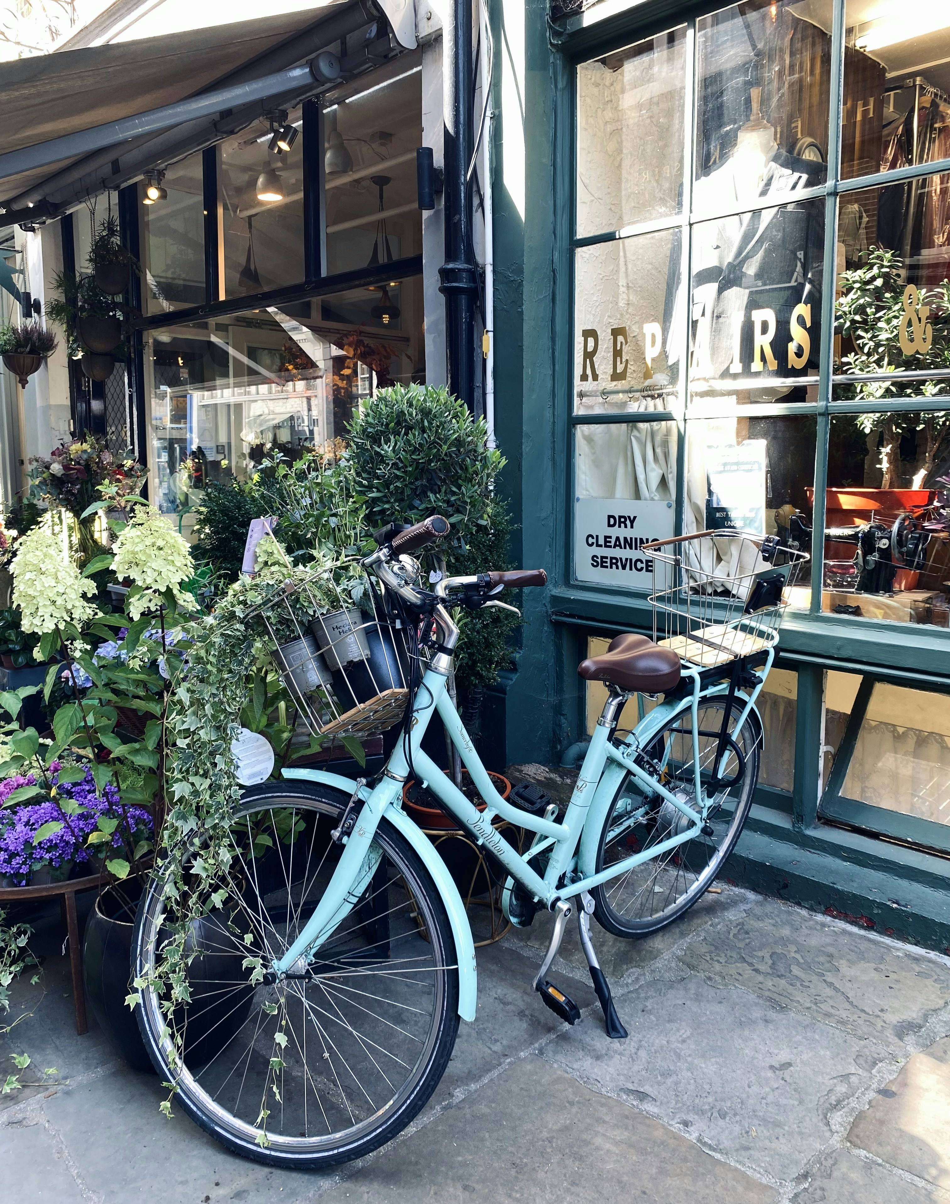 a bicycle parked outside of a flower shop
