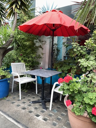 a patio with a table and chairs and an umbrella