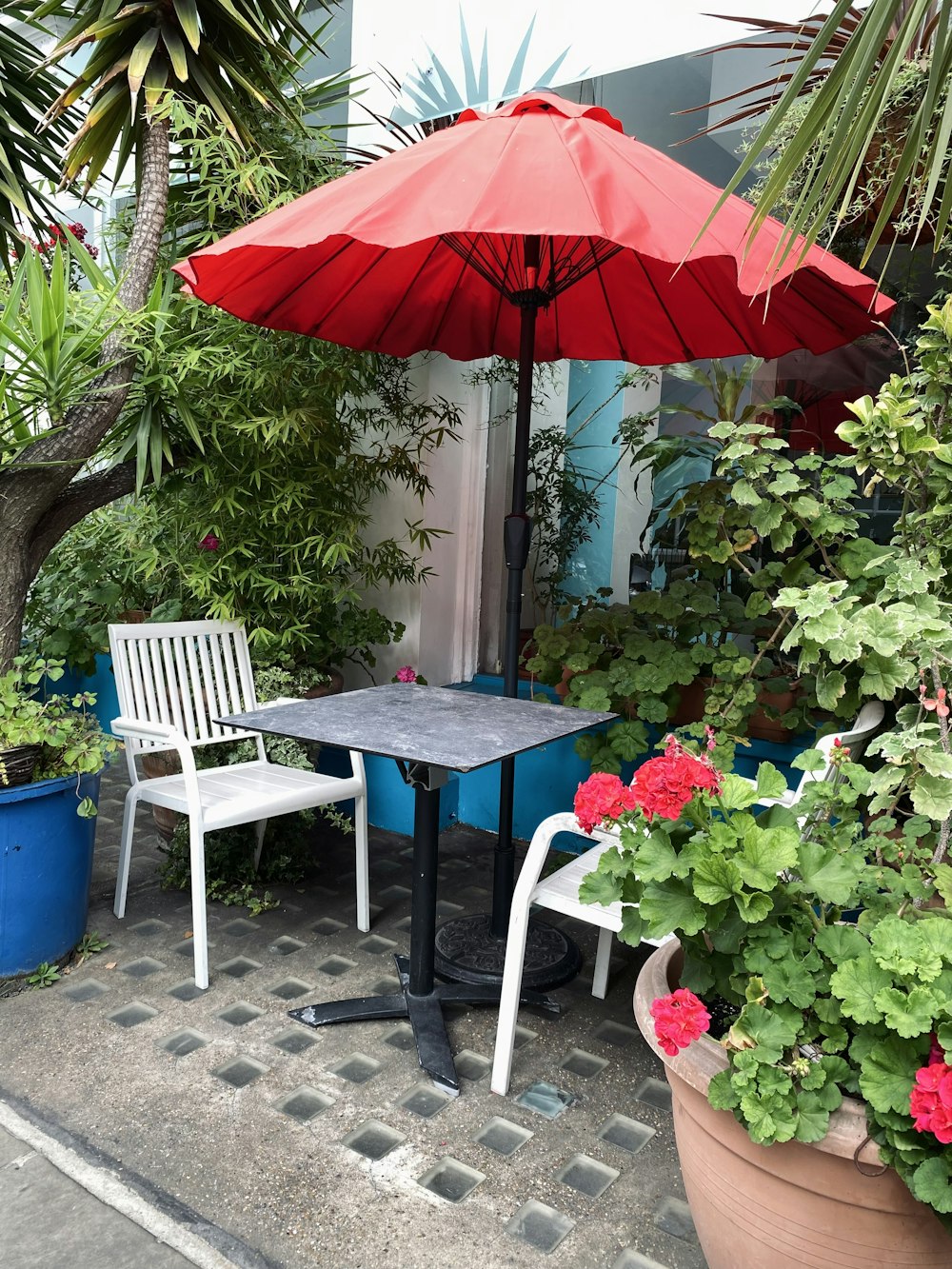 a patio with a table and chairs and an umbrella