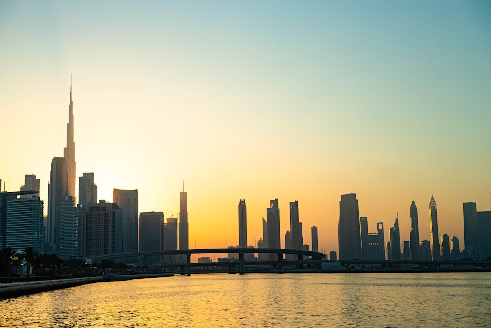 the sun is setting over the city skyline