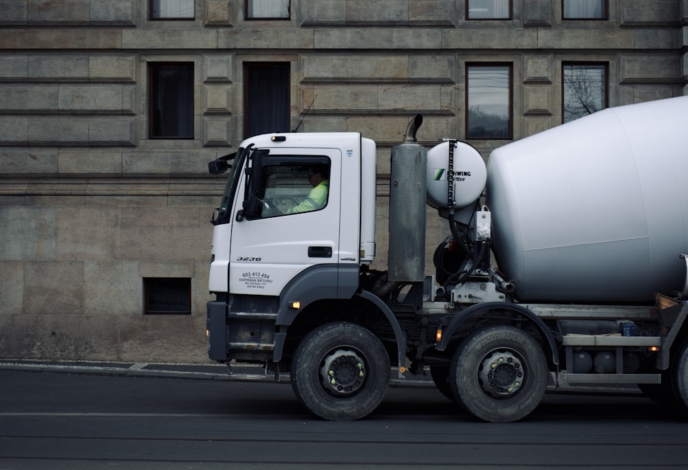 a cement truck parked in front of a building