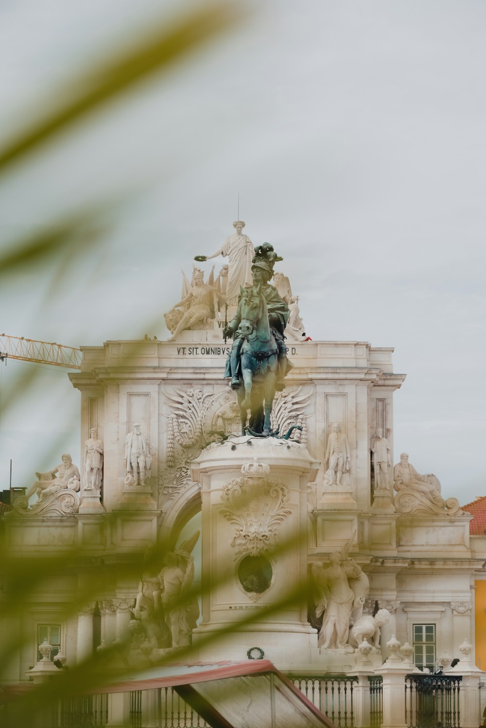 a statue of a man on a horse in front of a building