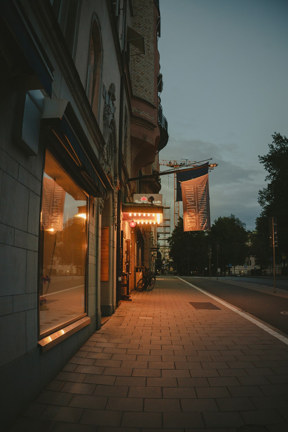 a city street at night with a store front