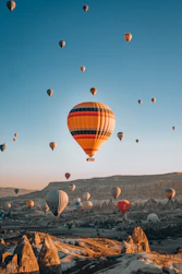 a bunch of hot air balloons flying in the sky