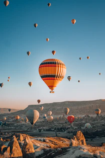 a bunch of hot air balloons flying in the sky